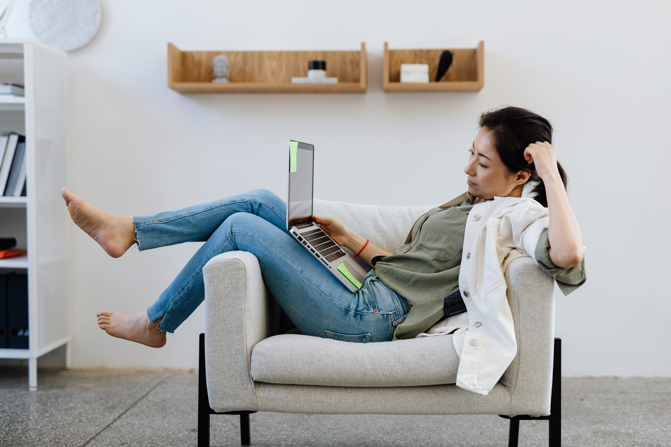 Woman Sitting Comfortable On An Armchair While Working